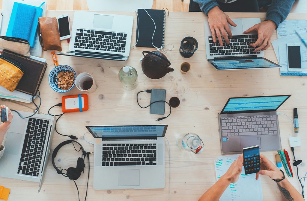 A shot from above of a table with laptops and other tech in a co-working space Image Marvin Meyer unsplash