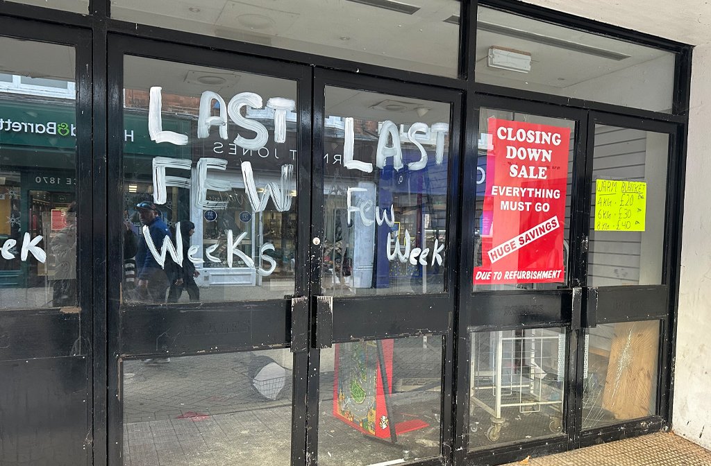 The windows of the deserted Beales building in Bedford town centre are daubed with paint and abandoned posters.