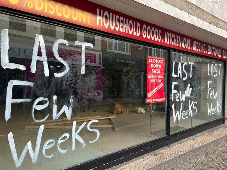 The windows of the deserted Beales building in Bedford town centre are daubed with paint and abandoned posters.