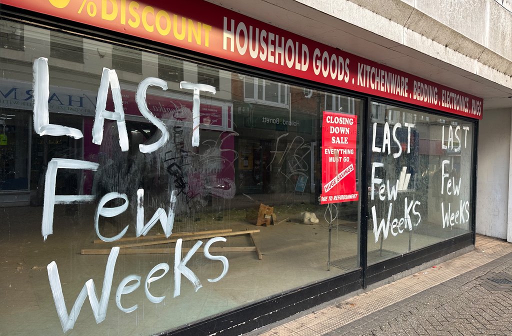 The windows of the deserted Beales building in Bedford town centre are daubed with paint and abandoned posters.