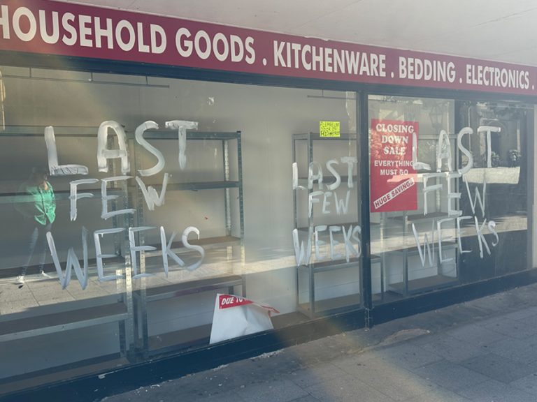 The windows of the former Beales store on Harpur Square have been left with paint daubed on the windows, ripped posters and fixtures and fittings left behind.