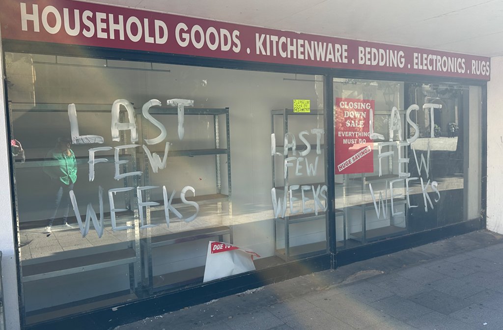 The windows of the former Beales store on Harpur Square have been left with paint daubed on the windows, ripped posters and fixtures and fittings left behind.
