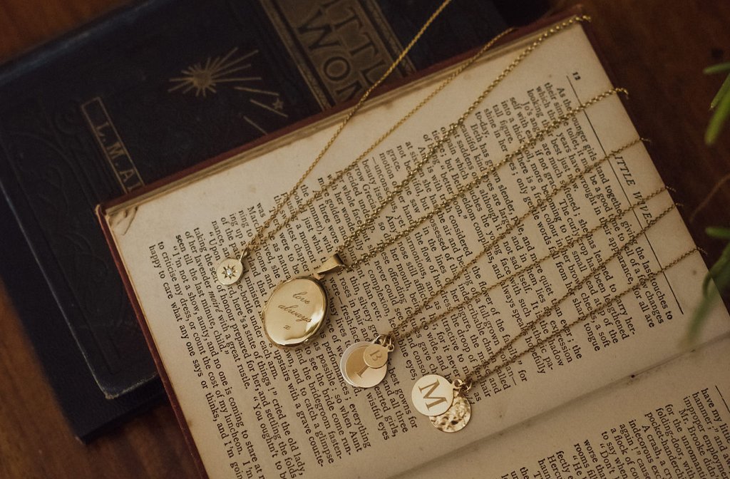 A selection of handmade jewellery at épanoui, displayed on an antique book