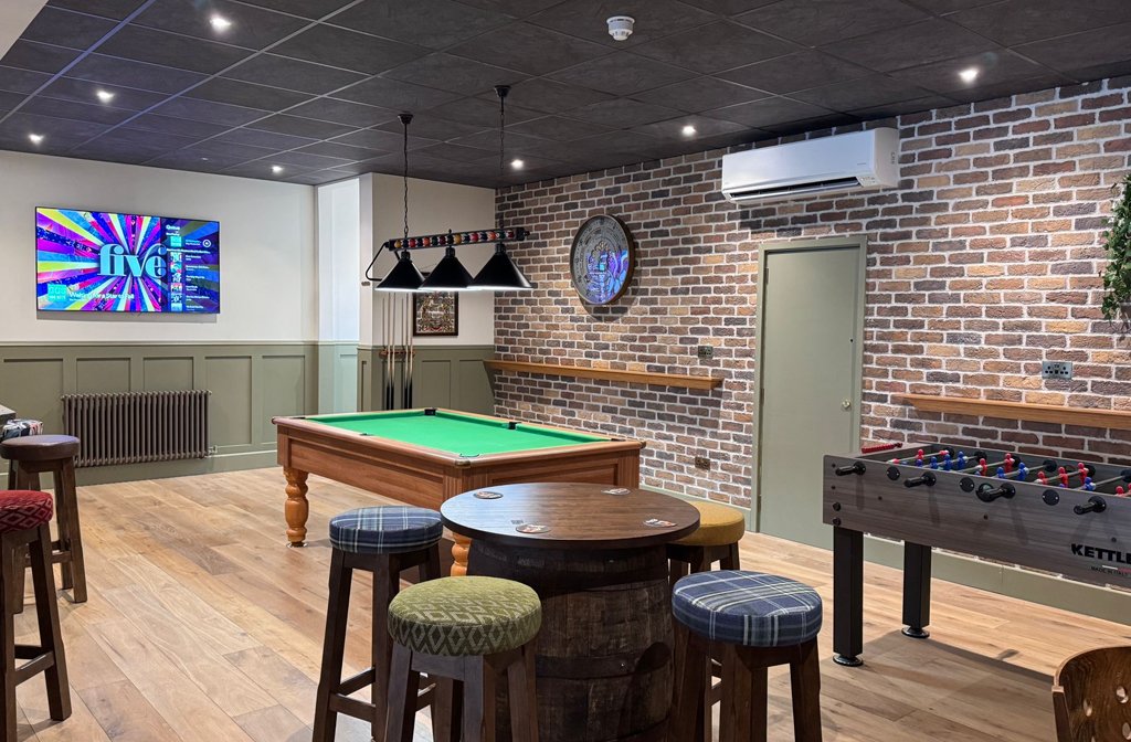 The pool table and table football area in the bar of the Hidden Barrel