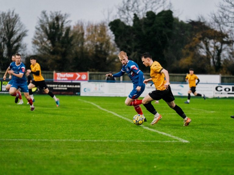 Real Bedford's Conor Tee takes on a Leiston defender in November 2025