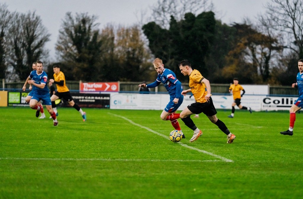 Real Bedford's Conor Tee takes on a Leiston defender in November 2025