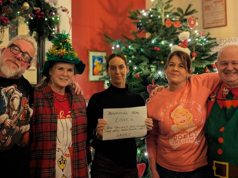 Ronnie and Rebecca Toms of the Devonshire Arms and quiz masters Jim and Moira are pictured handing over a cheque for £1,555 to Louise Ritchie, CEO of SMART, Bedford’s charity for the homeless.