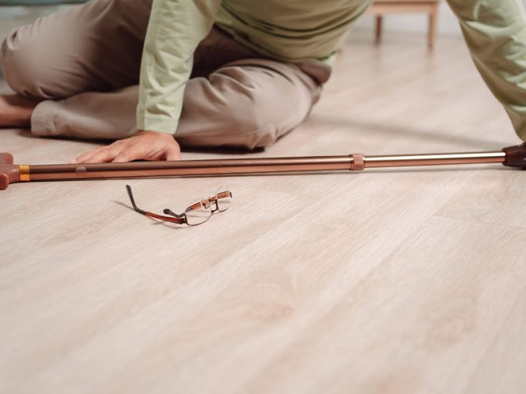 Elderly man fallen down with glasses and cane on the floor in front of him. Image: MMD Creative/Shutterstock