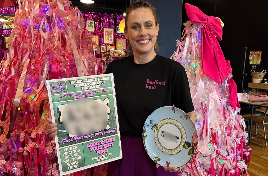 Gemma at the Arc holding some of their sweary products