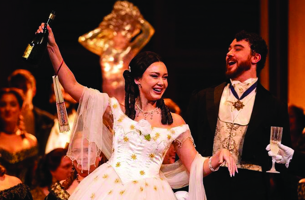 A man and a woman dressed in period costume perform La Traviata