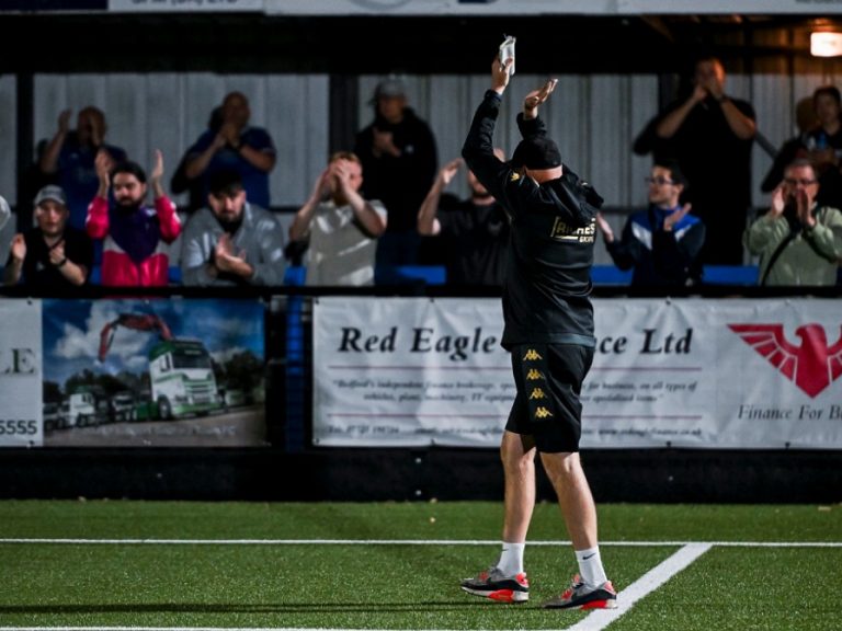 Bedford Town manager, Lee Bircham applauds fans at The Eyrie in September 2025