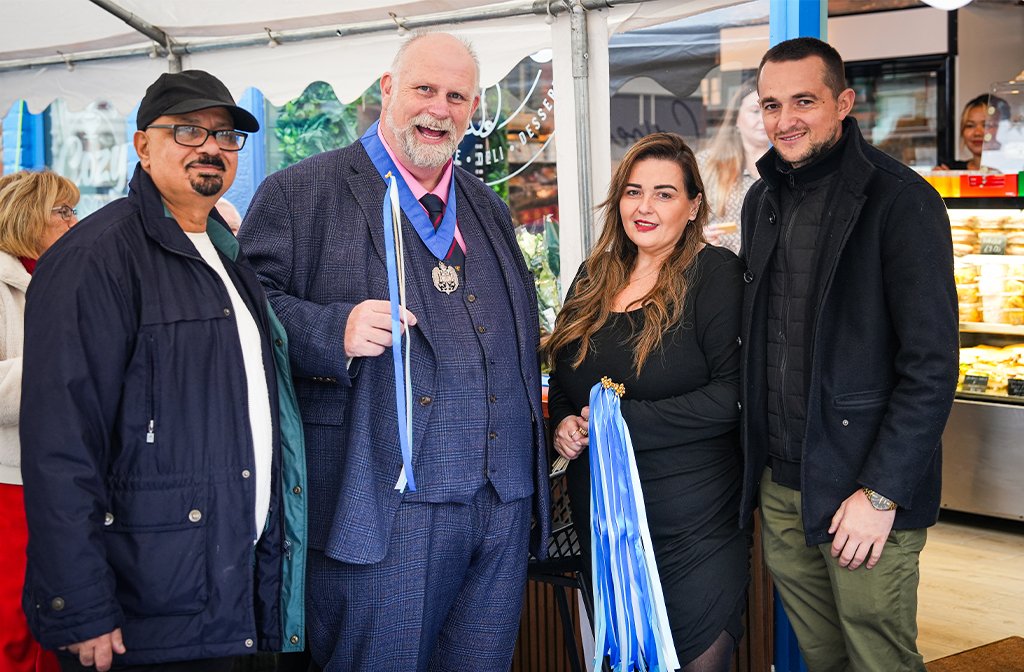 Mayor Tom Wootton with Sandy Christou to his left at the opening of Cozy, her new Greek deli on Castle Road. Image: Cozy