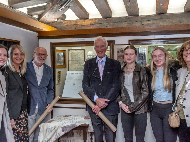 Peter Brown (left) and Richard Brown, and some of Peter's family at the the unveiling of the new John Bunyan family tree
