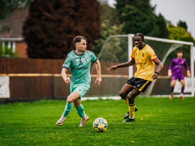 Conor Tee of Real Bedford faces up against an Alvechurch defender in the FA Trophy in November 2025