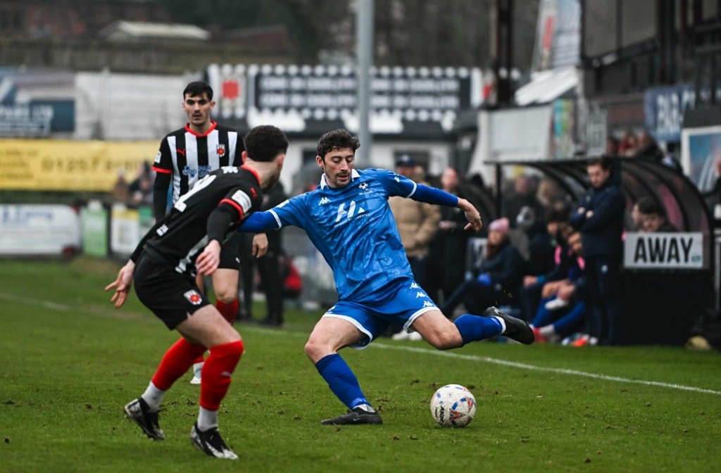 Bedford Town defender Sam Brown takes on a Chorley defender in November 2025