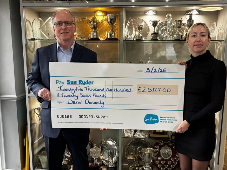 Bedfordshire Golf Club captain, David Donnelly and a member of the Sue Ryder team with a charity cheque