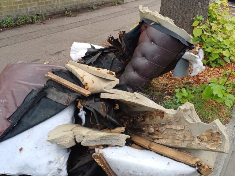 Fly tipped rubbish by the side of the road