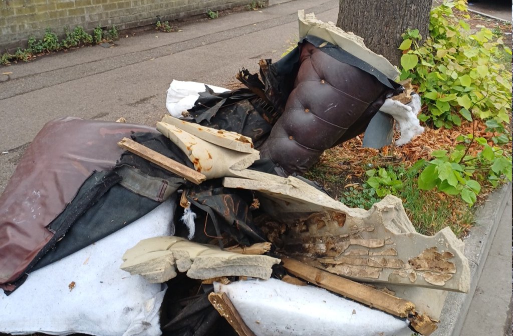 Fly tipped rubbish by the side of the road