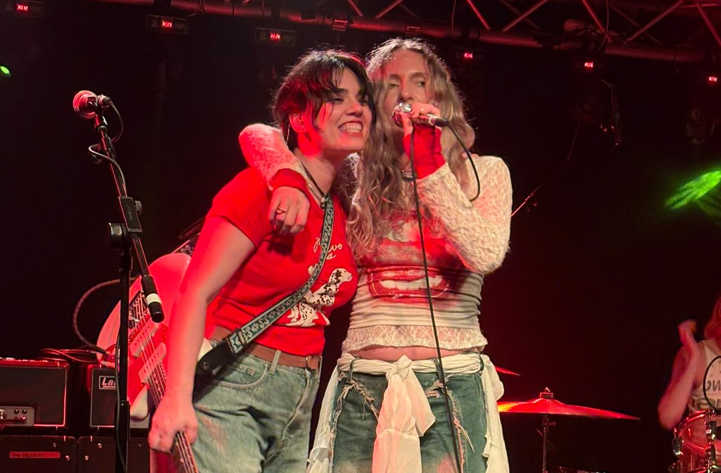 Two of the members of the band Carpark having a cuddle on stage at Esquires