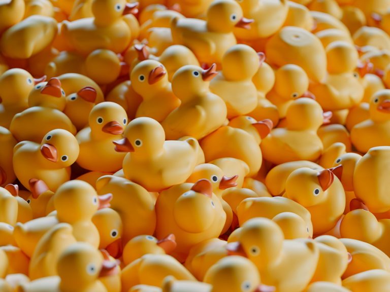 Closeup illustration CGI of a big pile of yellow rubber ducks stacked together. Image Dabarti CGI Shutterstock