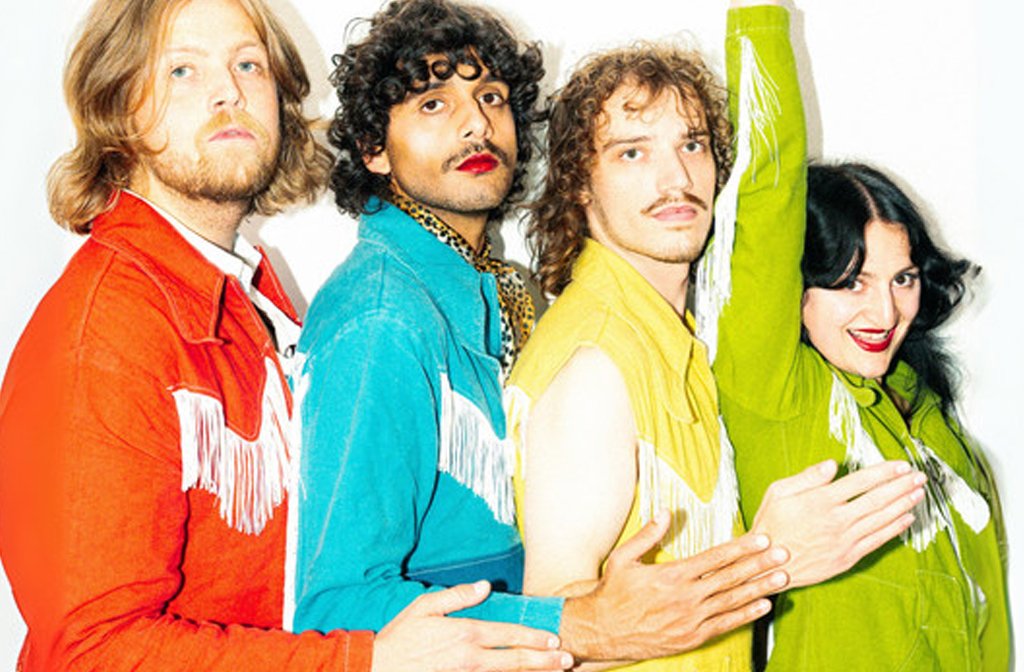 The members of the band Congratulations wearing colourful tasselled cowboy shirts