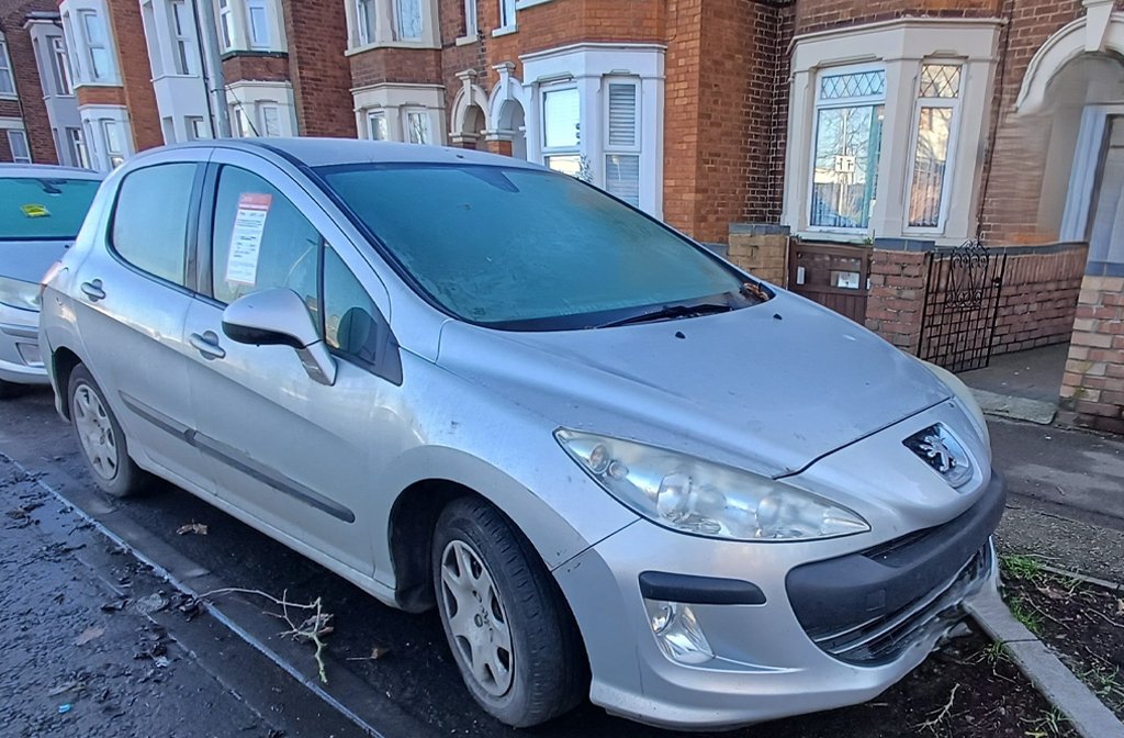 An abandoned car on a street in Bedford