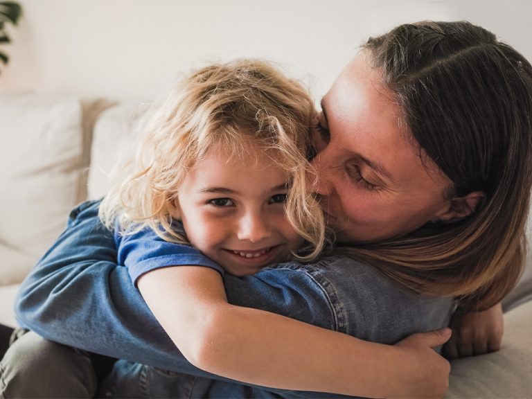 Happy parent and son hugging each other and having fun at home child family foster children parent Image Nuva Frames Shutterstock