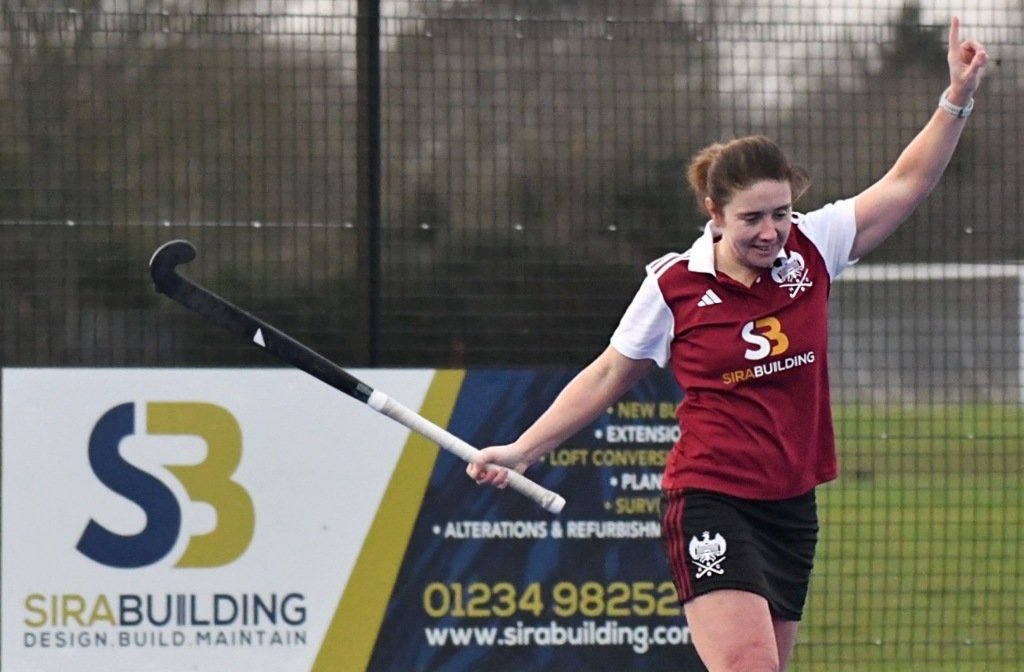 Kate Costin of Bedford Hockey Club Ladies 1st XI celebrates a goal