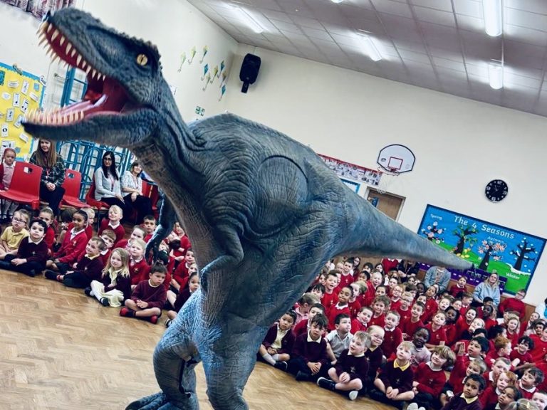 An animatronic T-Rex entertains children at Scott Primary School