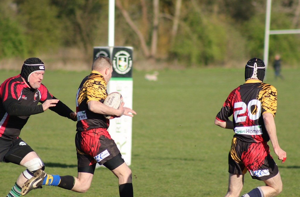 A Bedfordshire Super Vets player runs clear of a Buckinghamshire defender in their latest charity match at High Wycombe
