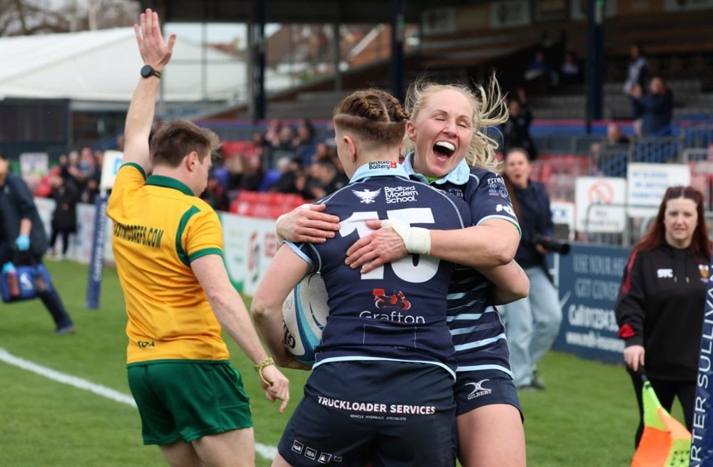 Claire Cranfield in the 15 jersey celebrates a try with teammates at Goldington Road