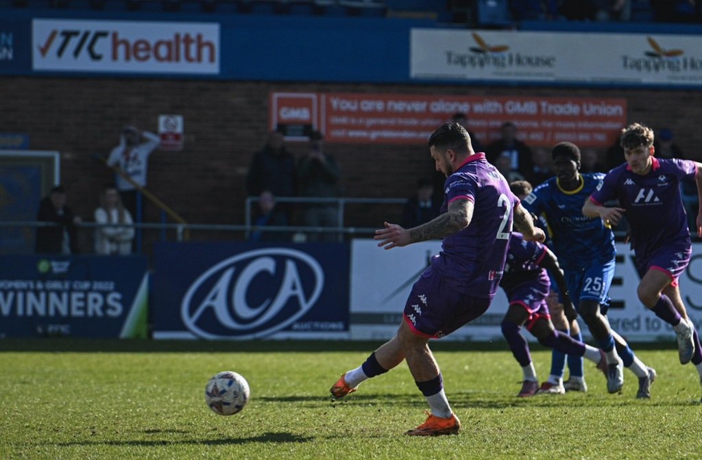 George Moncur slots home the winning penalty at Kings Lynn