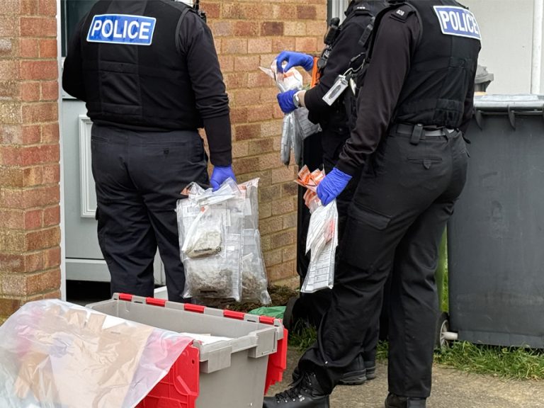 Officers seizing Class B drugs and cashduring County Lines Intensification Week operation March 2026 Image Bedfordshire Police
