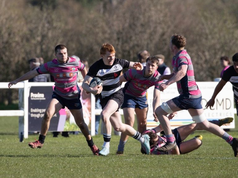 A Bedford Ath rugby player palms off a tackle at Olney in March 2026
