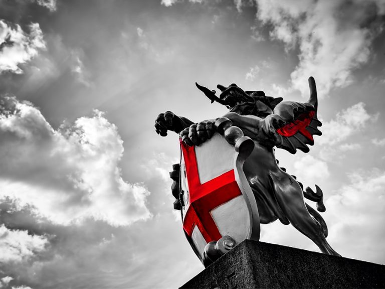 St. George dragon statue in London, the UK. Symbol of England. Black and white with red St. George's Cross Image: PHOTOCREO Michal Bednarek shutterstock