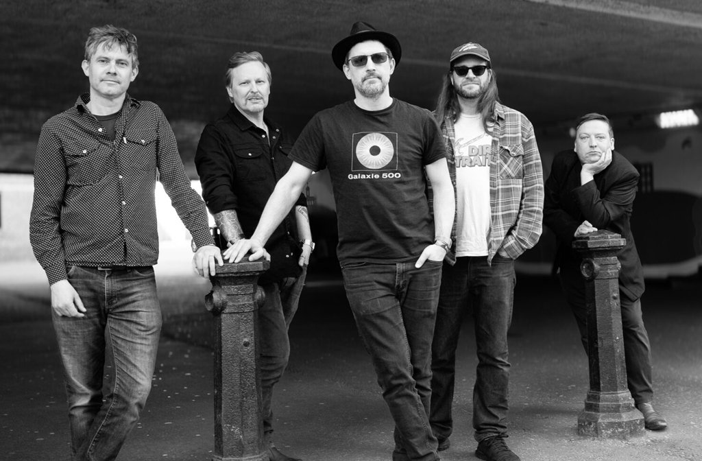 The five members of The Dreaming Spires photographed in black and white under and underpass