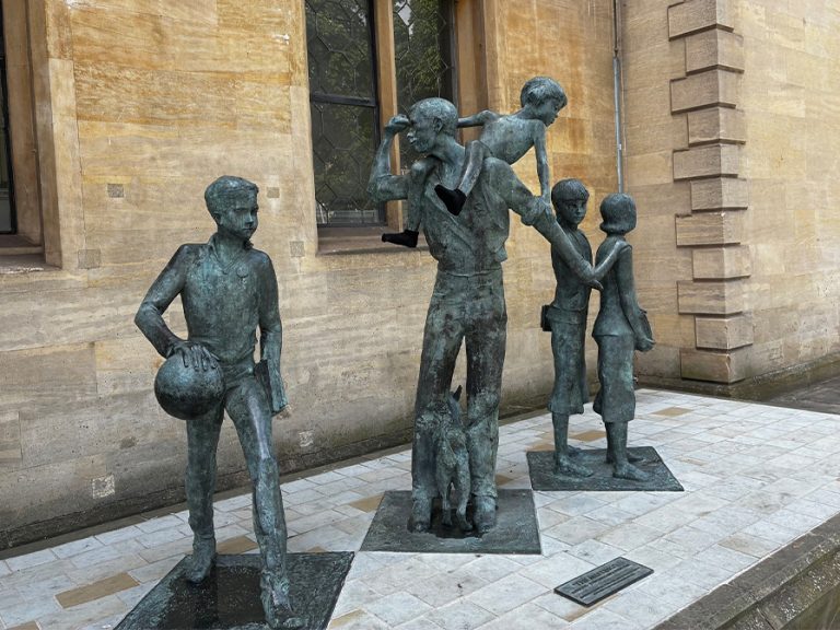 'The Meeting' statue with socks on outside Bedford Old Town hall. Image: Bedford Borough Council