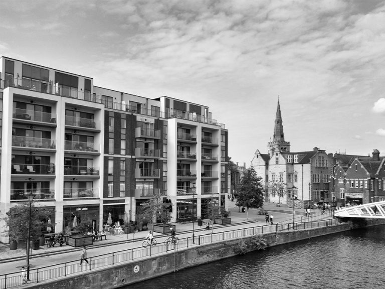 Black and white image of modern buildings along the River Great Ouse in Bedford, England. Image: Altaf Shah/Pexels
