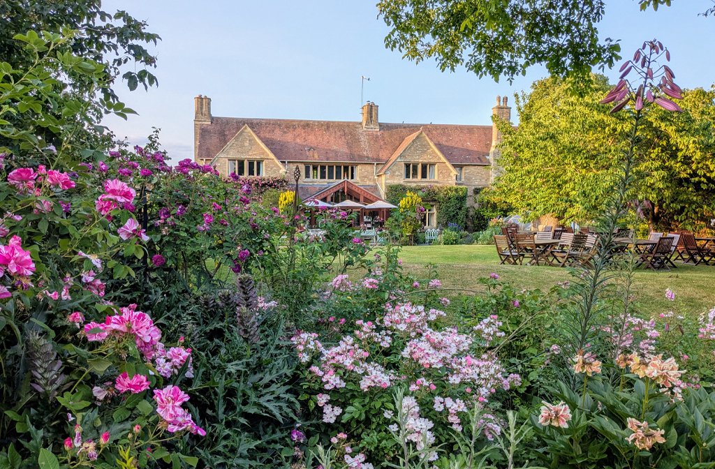 Kathy Brown's Garden in mid June, with the Manor House in the background.