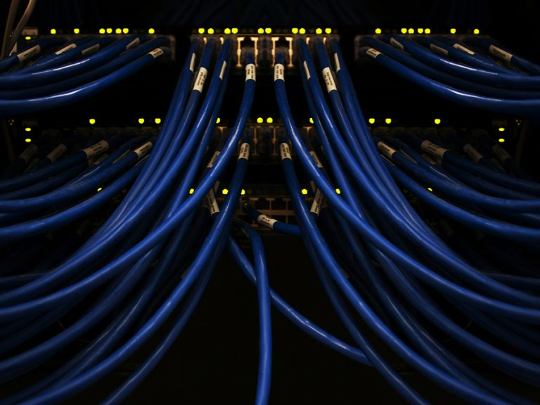 a bunch of blue wires connected to each other and a computer server Image Scott Rodgerson Unsplash