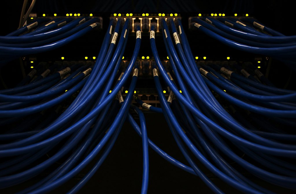 a bunch of blue wires connected to each other and a computer server Image Scott Rodgerson Unsplash