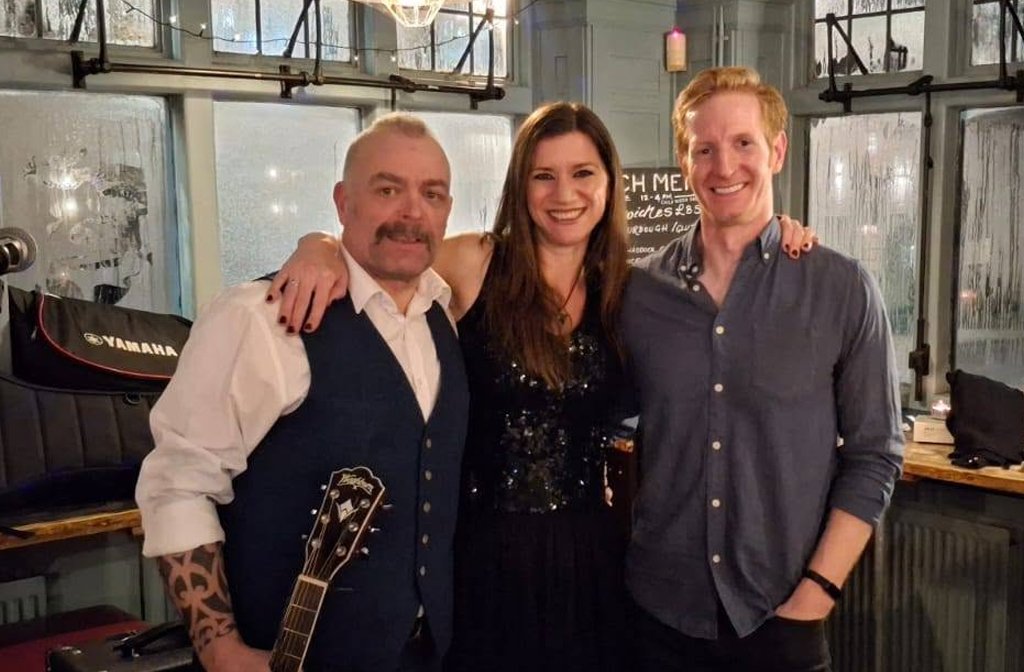 Claire Cameron flanked by musicians Dan and Alex