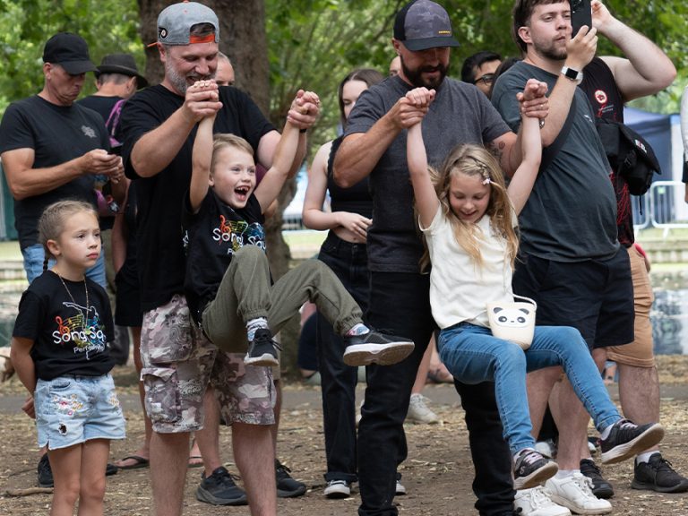 Fans watching Givemeyourteeth, BBC introducing stage playing guitar Bedford River Festival 2026