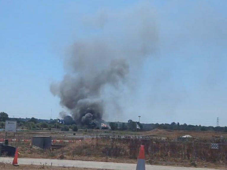 Plumes of smoke reach high into the sky above a fire at Kelpie Marine on the A1 at Roxton Image Georgia Bossendorfer