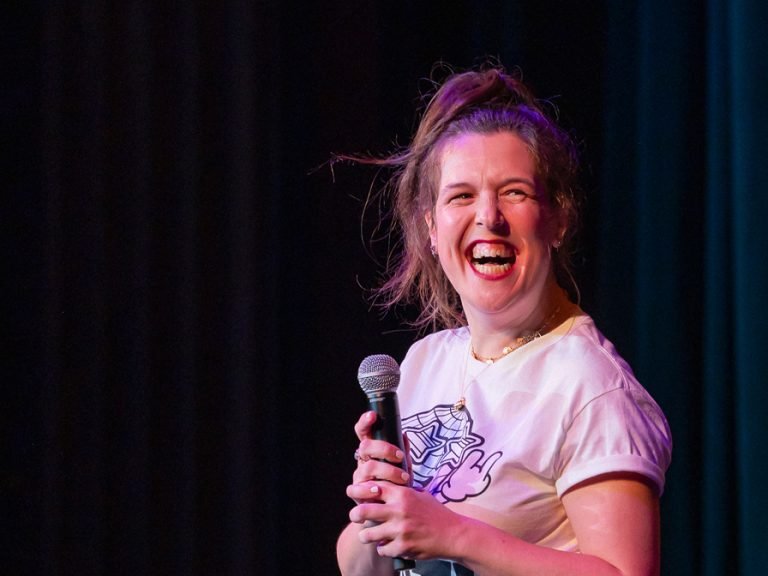 The comedian and disability advocate Rosie Jones performing on stage
