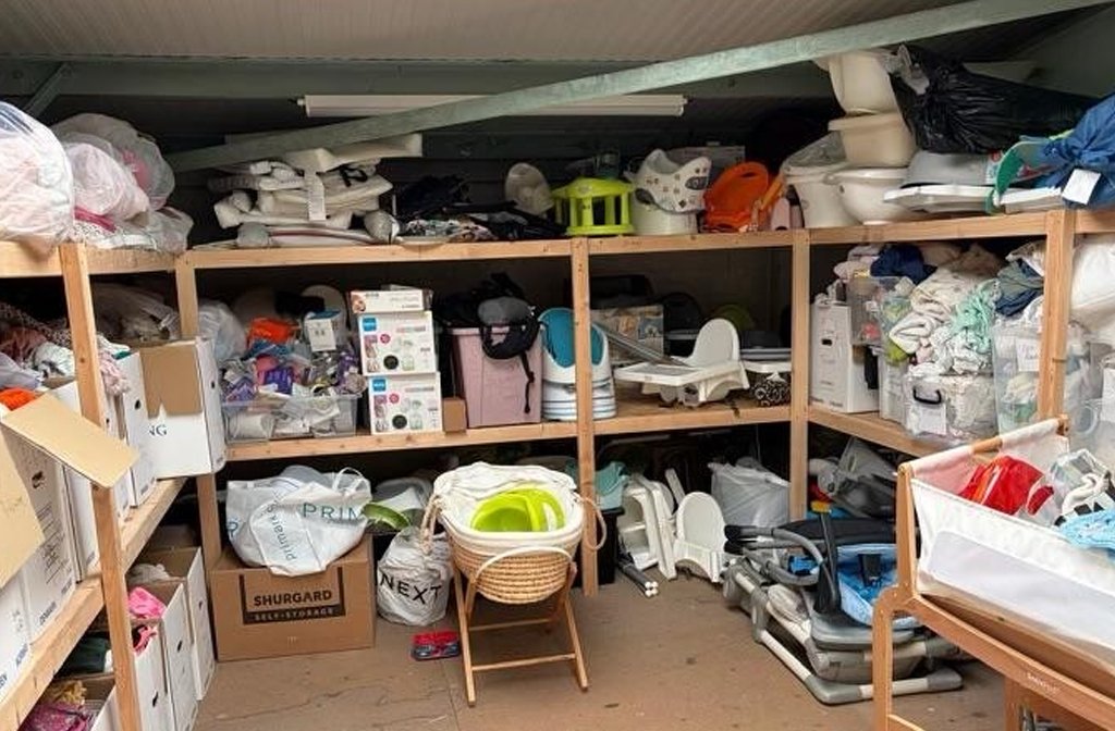 A selection of the items provided to families in need by FACES BabyBank. The warehouse shelves have baby essentials and there is a Moses basket, potties and other equipment.