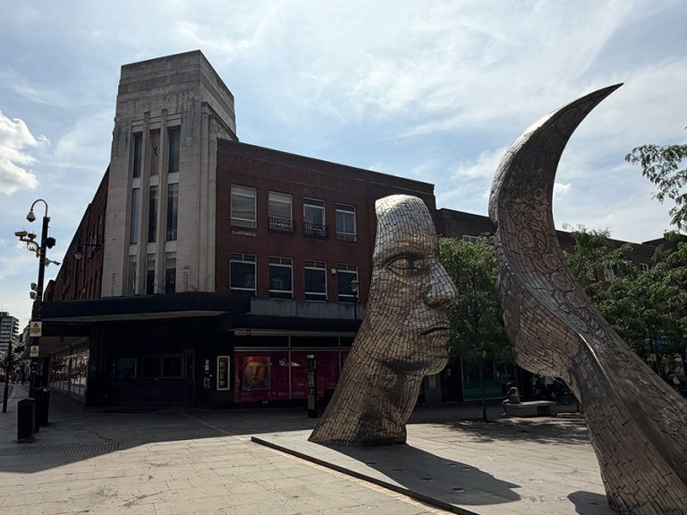 The former Debenhams building and the 'faces' at the top of Silver Street and Bedford High Street Image Bedford Independent