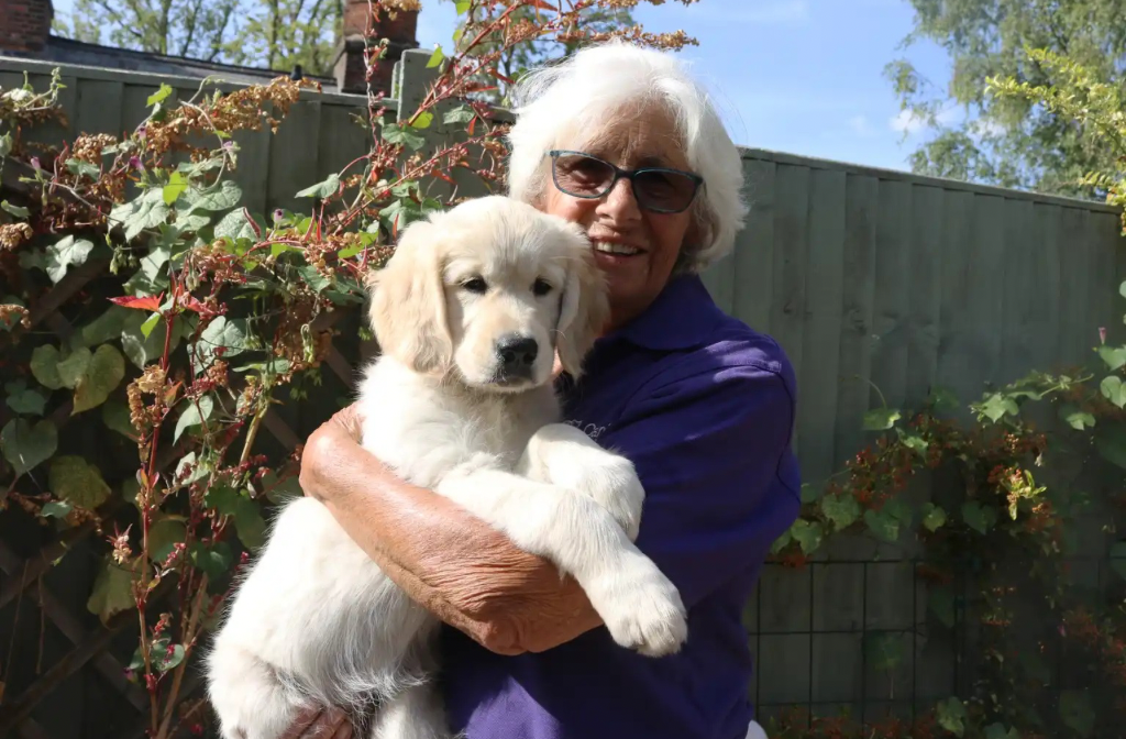 Canine Partners training volunteer with puppy
