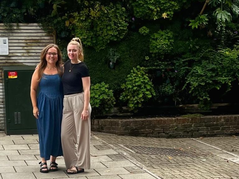 Caroline and Rosanna in front of the living wall on St Cuthbert's Street.