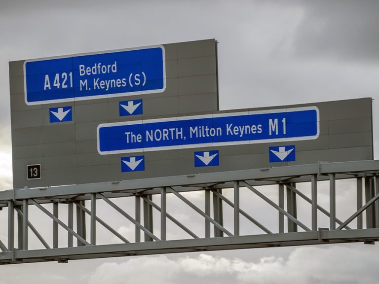 Close up view of J13 M1 highway (A421 Bedford MK) signs against cloudy sky in England Image Pajor Pawel Shutterstock